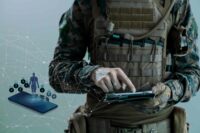 Soldat frontal mit Tablet und Mobilfunksymbolen, Militär, Verteidigung, Spionageabwehr